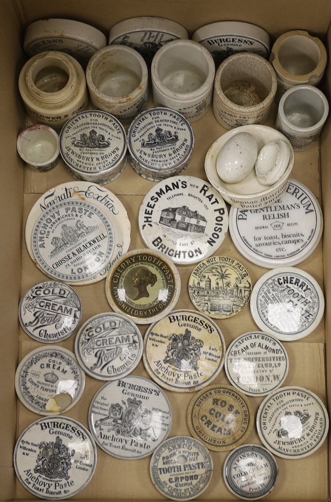 A large collection of anchovy paste toothpaste pot lids and pots together with a Brighton Cheesmans rat poison pot lid